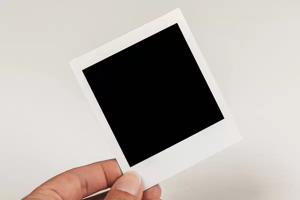 Instant Polaroid photo in a woman's hand
