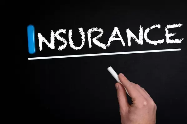 Insurance text on blackboard