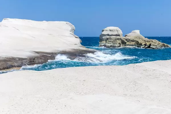 Interesting rock formations meet the waves of the Aegean sea on the deserted coast of Milos, Greece