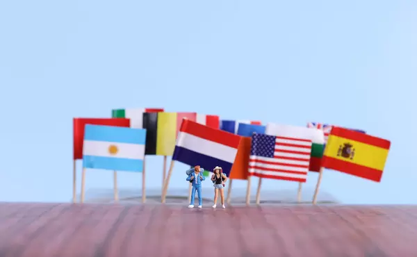 International flags with two travelers