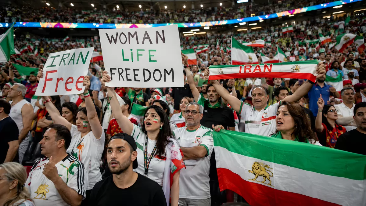 Iranische Fans protestieren mit Schildern im Stadion