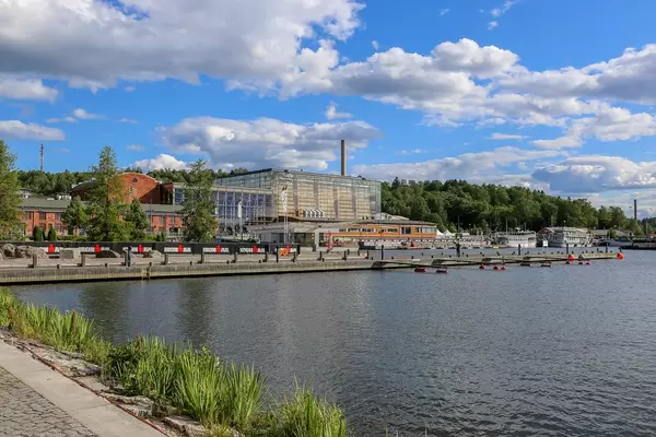 Ironman advertising in front of glass building and concert hall "Sibelius hall" in Lahti, Finland, next to Lahden Sataman Helmet at Lake Vesijärvi