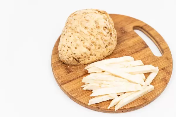 Isolated Sliced Celery Root on the cutting kitchen board