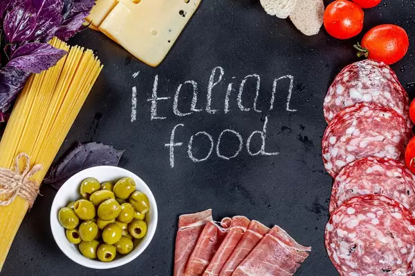 Italian food products with tag on black background