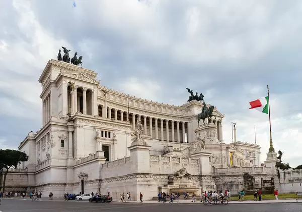 Italian Parliament Building in Downtown Rome with Italian Flag on Flag Pole at Cloudy Weather