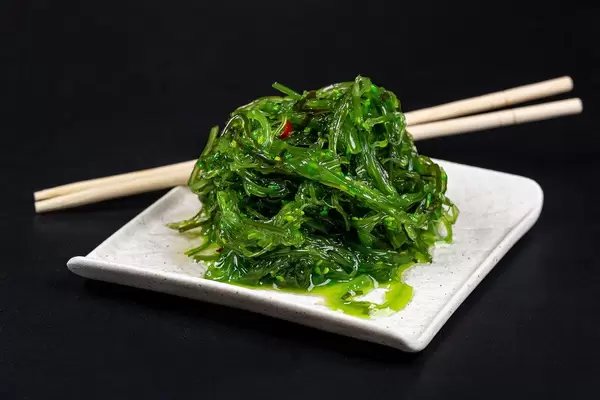 Japanese cuisine - chuka seaweed salad, served with nuts sauce and sesame