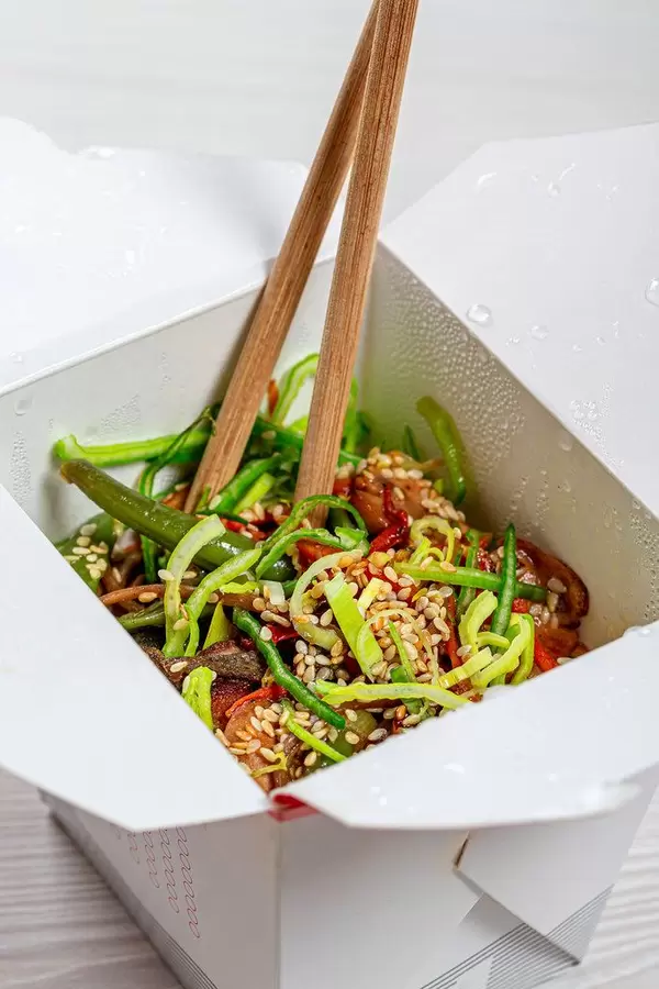 Japanese food: Soba noodles with mushrooms, broccoli, carrots, peppers close-up with chopsticks