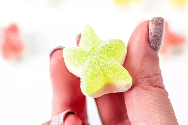Jelly candy star in a woman's hand close up (Flip 2020)
