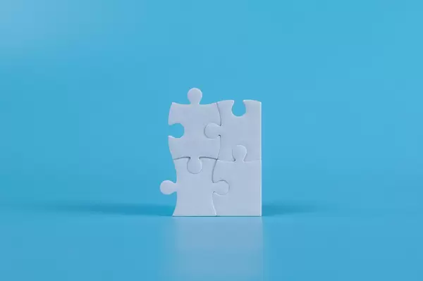 Jigsaw puzzle pieces on blue background