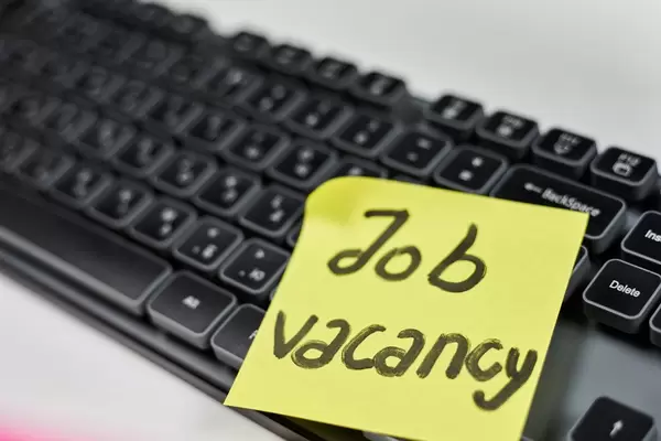 Job recruitment advertisement. Job vacancy - phrase written on the sticky note. HR, Recruitment concepts