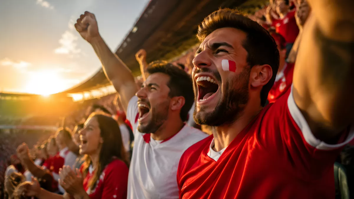 Jubelnde Fußballfans in Rot-Weiß im Stadion