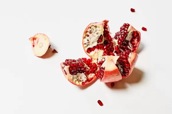 Juicy pomegranate fruit on white background