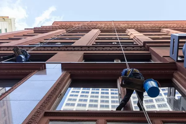 Just attached to a rope: professional window cleaners working on the outside of a building in Chicago