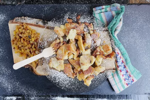 Kaiserschmarrn on black background, Austrian cuisine (Flip 2019)
