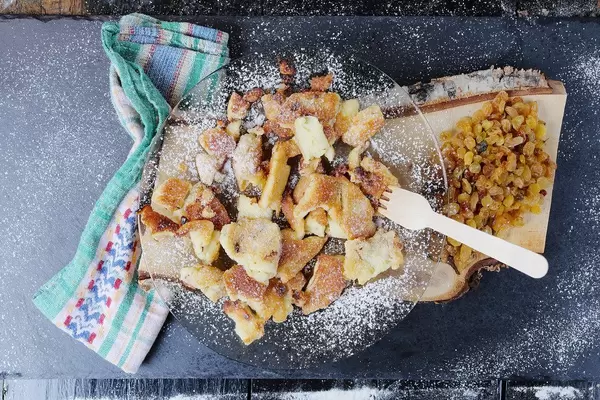 Kaiserschmarrn on black background, Austrian cuisine