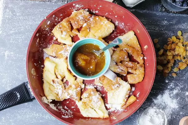 Kaiserschmarrn with jam and raisins in pan
