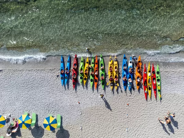 Kajak fahren auf Skopelos, Griechenland: Draufsicht auf viele bunte Kajaks, aufgereiht am Strand von Milia