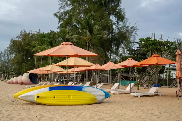 Kayak, Sunbeds and Sun Umbrellas on the Sand Beach at Sunset Sanato Beach Club in Phu Quoc, Vietnam