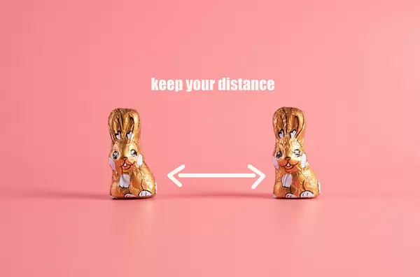 Keep your distance concept with two chocolate easter bunnies