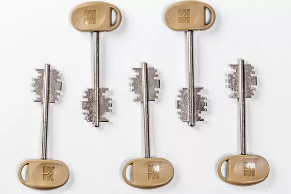 Keys to the door lock on white background