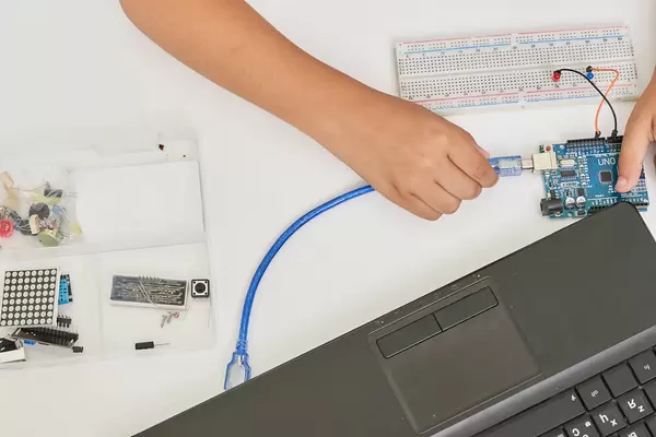 Kid programming electric toys and robots at robotics classroom