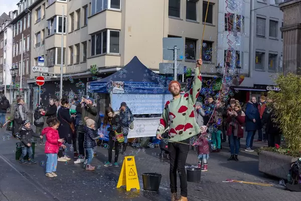 Kids trying to catch soap bubbles