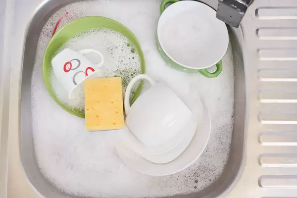Kitchen sink full of dirty dishes