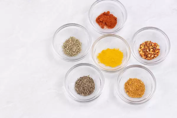 Kitchen Spices in the glass bowls on the table