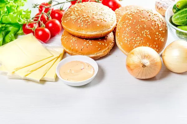 Kitchen table with ingredients for cooking burgers (Flip 2019)