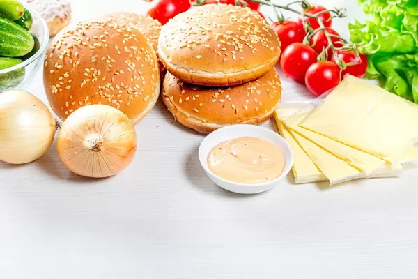 Kitchen table with ingredients for cooking burgers