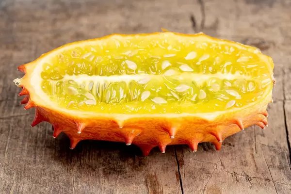 Kiwano fruit half on old wooden background