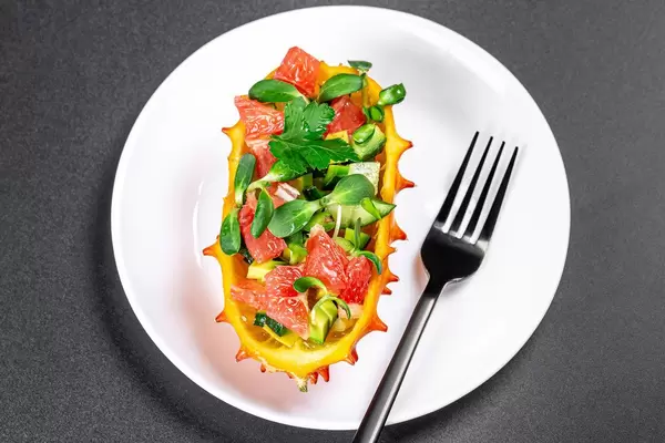 Kiwano with avocado, grapefruit and sunflower microgreen. Healthy eating concept (Flip 2020)