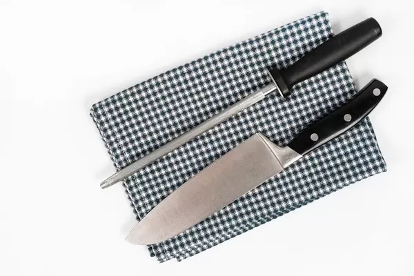 Knife-and-Knife-Sharpener-on-the-kitchen-dishcloth-on-the-white-background.jpg