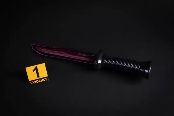 Knife with grungy blood and evidence marker