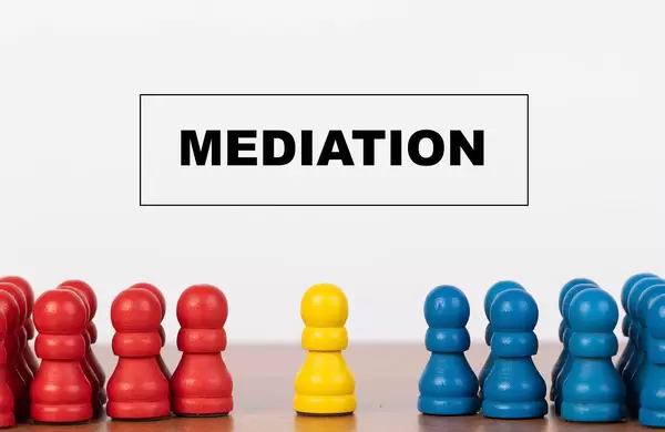 Konfliktvermittlung: Mediation-Konzept mit Bauern / Spielfiguren auf einem Tisch