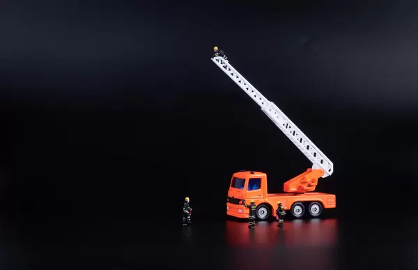 Ladder fire engine on black background