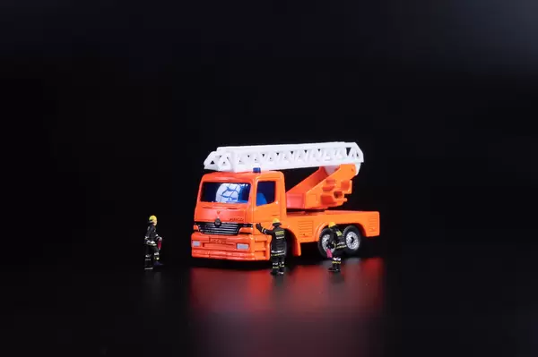 Ladder fire engine with miniature firefighters