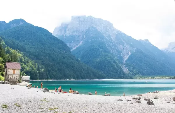 Lake Predil with turquoise water and mountains in background near Tarvisio in European Alps