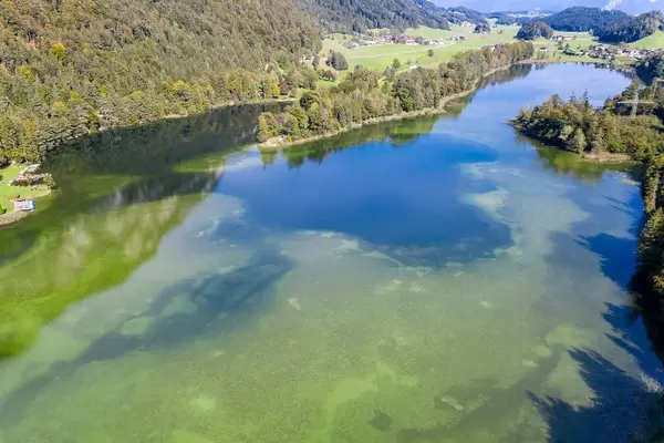 Lake Reintal: the largest of the Kramsach Lakes in the Alpbach Valley. Aerial view in autumn