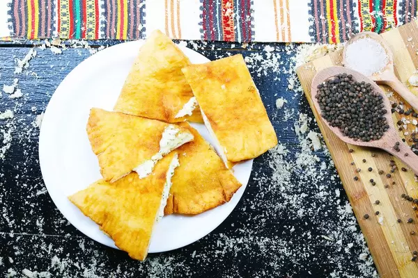 Langos, salted cheese donuts, black background. Hungarian cuisine (Flip 2019)