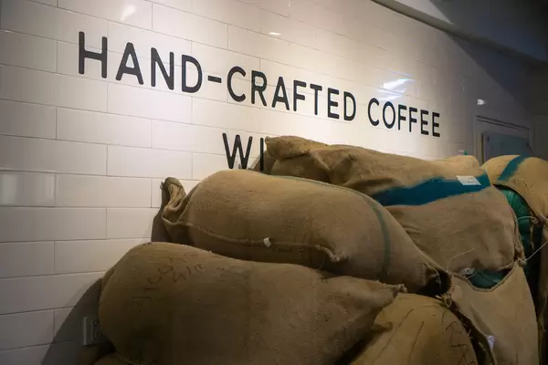 Large Burlap Coffee Bags with Freshly Roasted Coffee Beans in a Cafe and Restaurant in Ho Chi Minh City, Vietnam