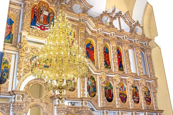 Large chandelier in the Church on the background of Christian icons