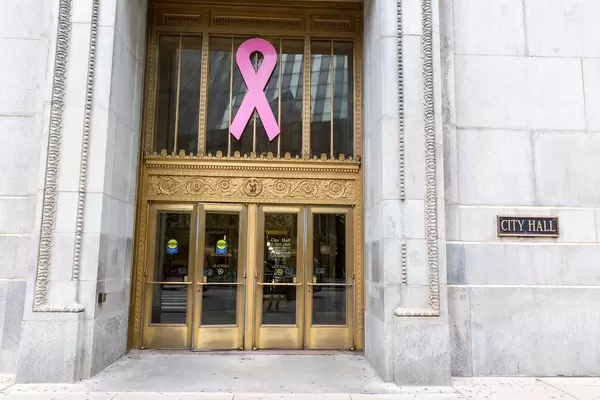 Large pink ribbon for breast cancer awareness at the entrance of the City Hall in Chicago