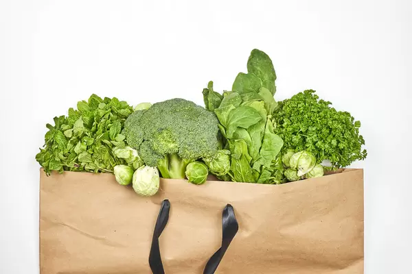 Leafy greens in the paper shopping bag