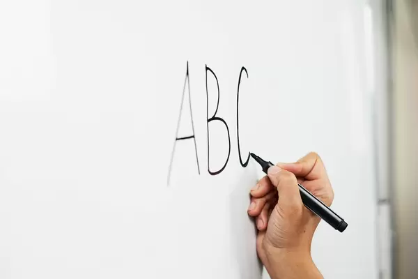 Learning English alphabet. A teacher starting first English lesson for beginners