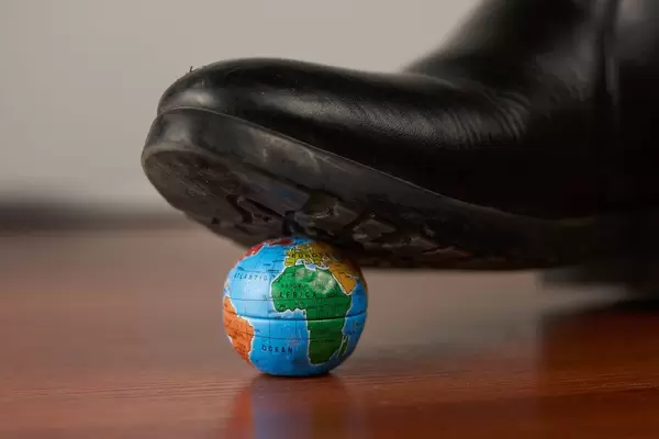 Leather shoes tramples Earth. Post coronavirus world or ecological and environmental problems concepts