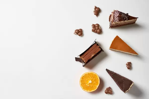 Leckere Torten: Schokoladentorte, Käsekuchen, Tiramisu vor weißem Hintergrund mit Platz für Text