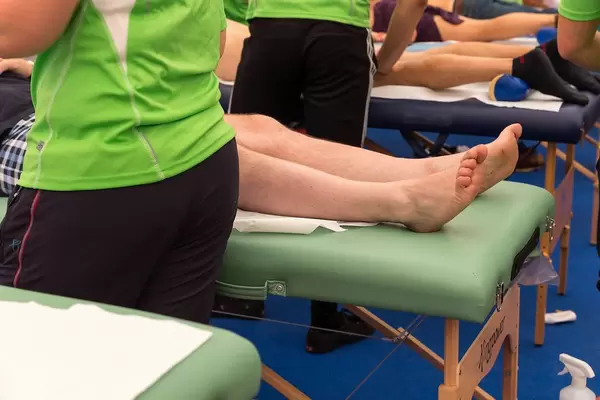 Legs of a person being treated by a physiotherapist