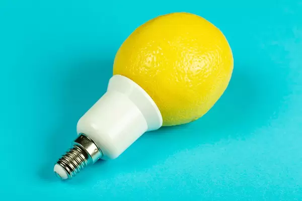 Lemon light bulb on blue background