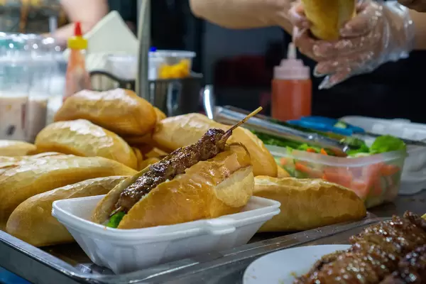 Lemongrass Pork Skewer in a Banh Mi Baguette sold at a Street Food Cart at the Phu Quoc Night Market in Vietnam
